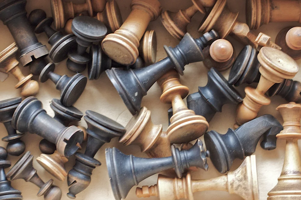 A collection of vintage wooden chess pieces, illustrating wooden chess sets